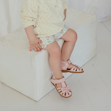 Starter sandal with a bow and velcro closure