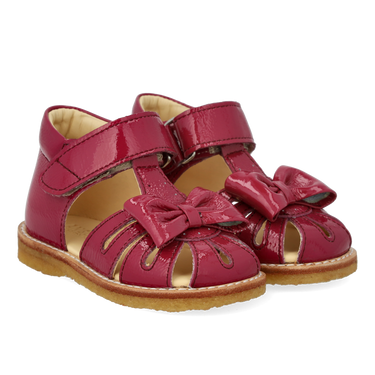 Starter sandal with a bow and velcro closure