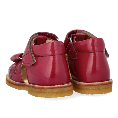 Starter sandal with a bow and velcro closure