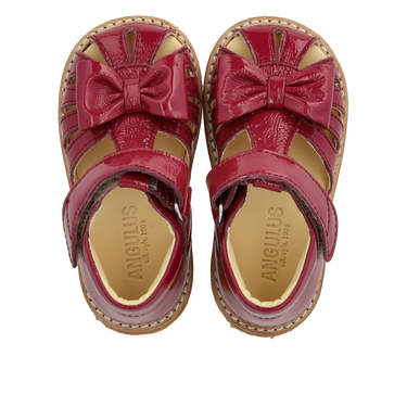 Starter sandal with a bow and velcro closure