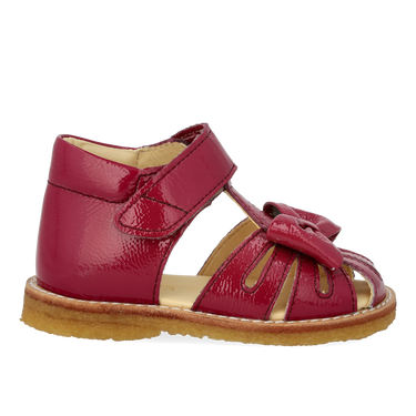 Starter sandal with a bow and velcro closure