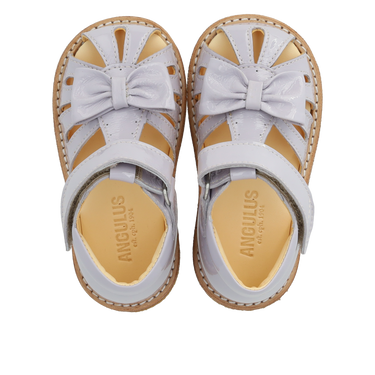 Starter sandal with a bow and velcro closure