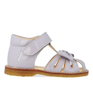 Starter sandal with a bow and velcro closure