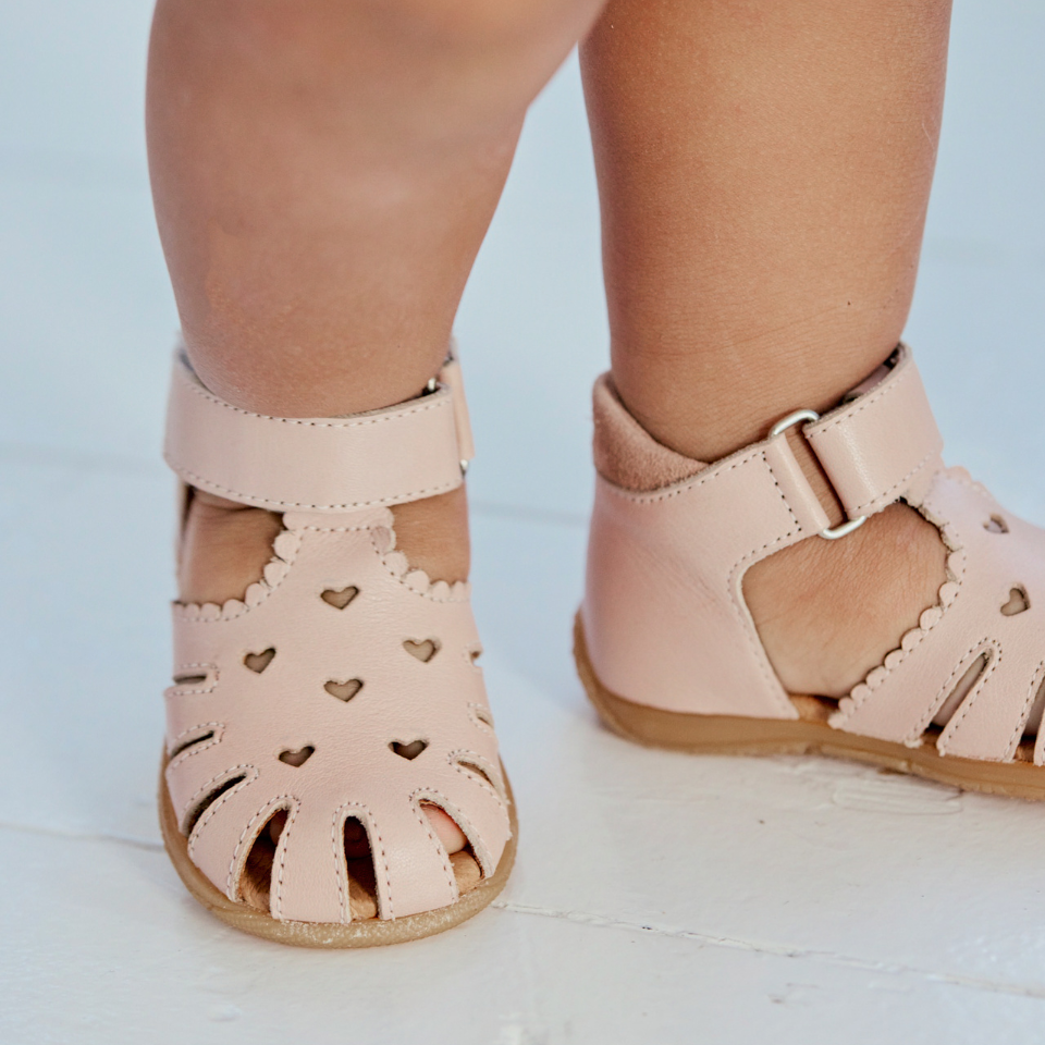 first steps sandal with a cut-out heart pattern