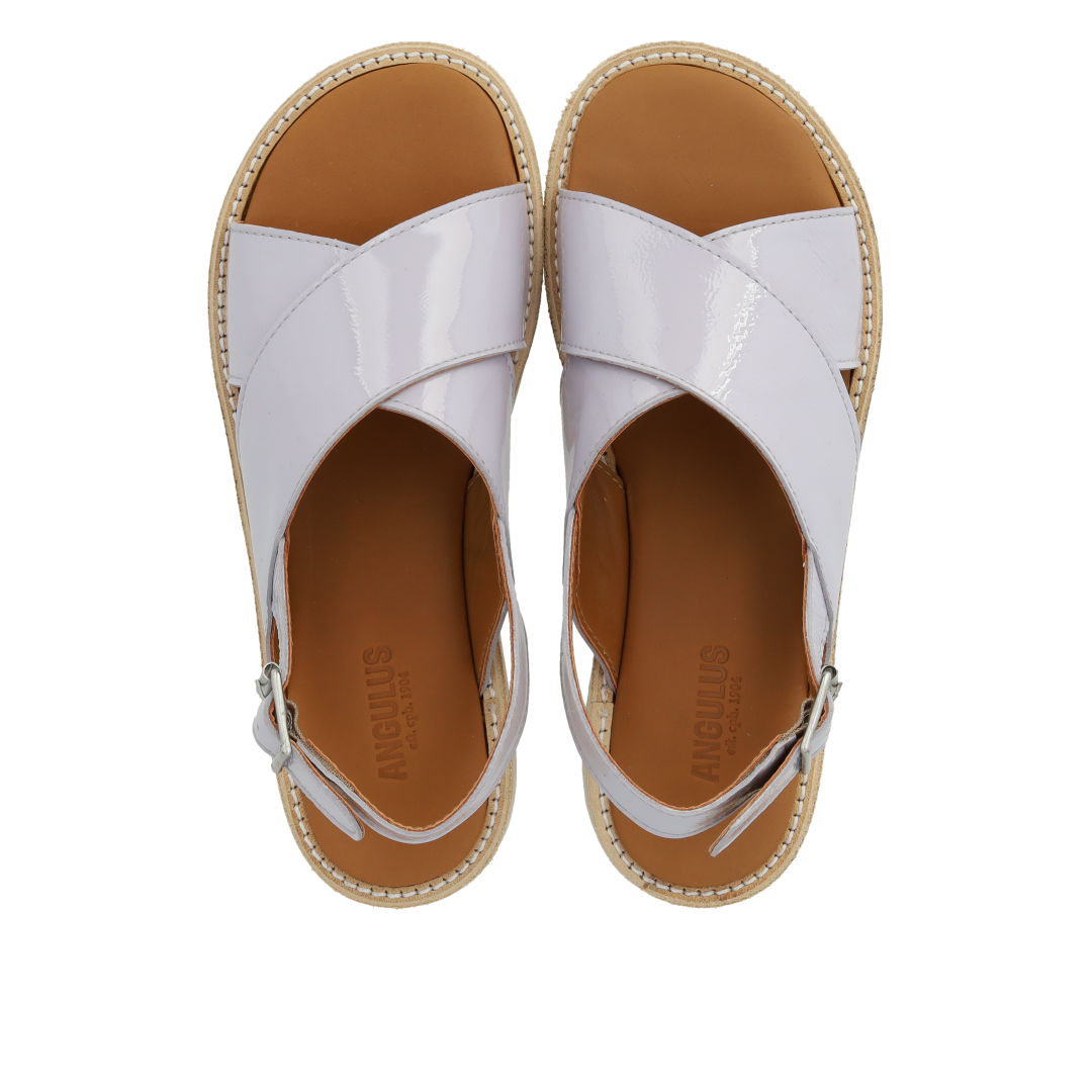 Cross-strap sandal with buckle fastening