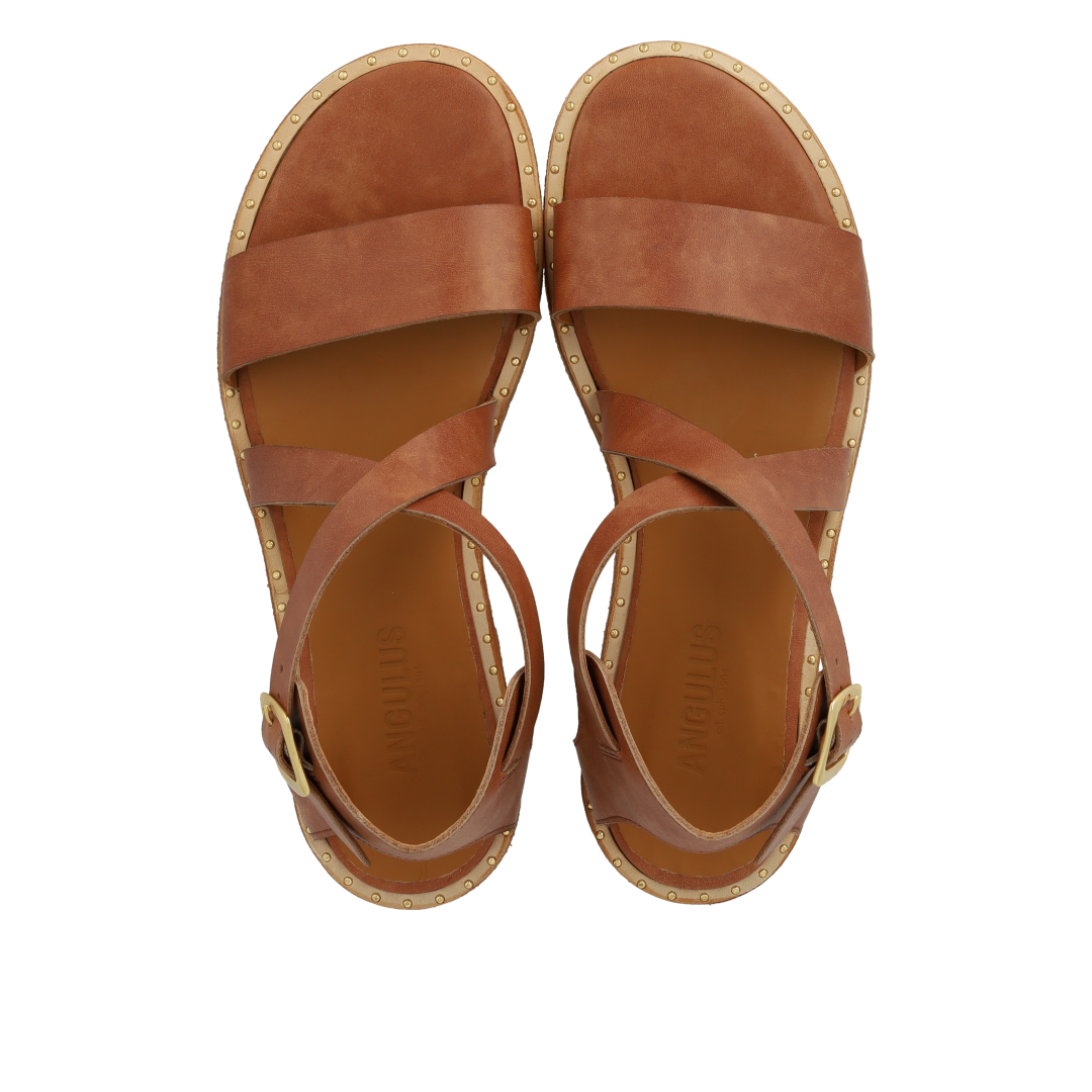 Sandal with crisscross straps and ankle buckle